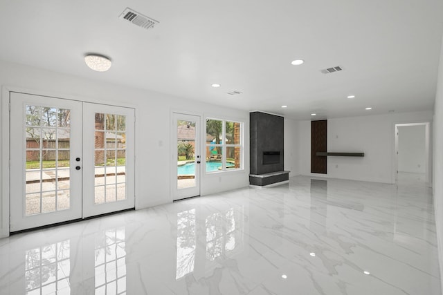 unfurnished living room featuring french doors, visible vents, and marble finish floor