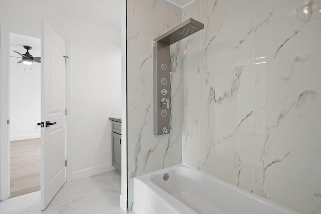 bathroom featuring vanity, baseboards, a ceiling fan, marble finish floor, and washtub / shower combination