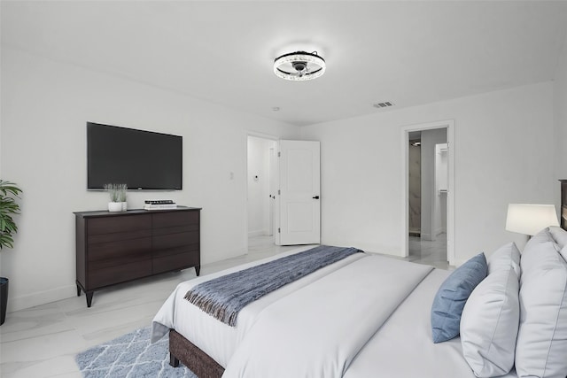 bedroom featuring marble finish floor, visible vents, and baseboards