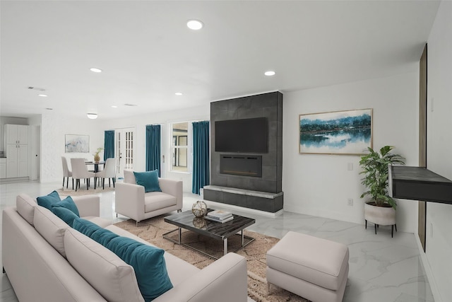 living room with recessed lighting, marble finish floor, and a fireplace