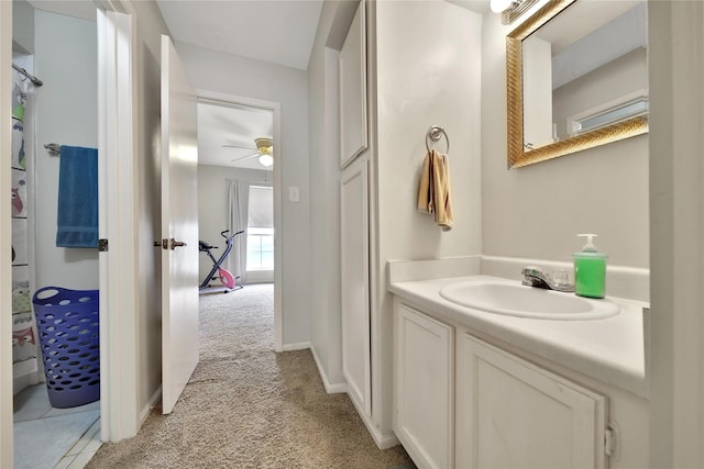 bathroom featuring ceiling fan, vanity, and baseboards