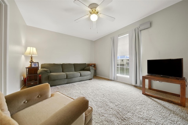 carpeted living area with a ceiling fan and baseboards