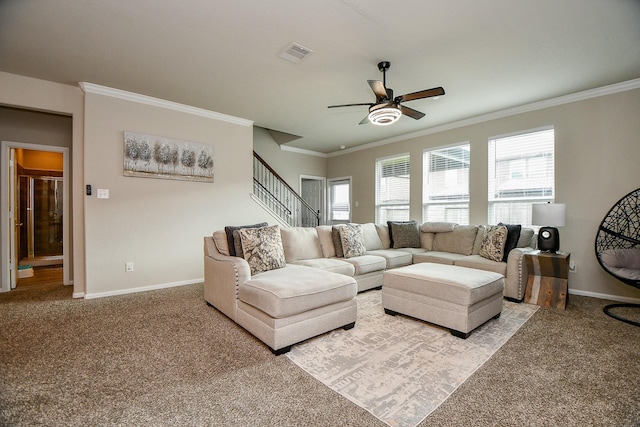 living area featuring baseboards, ceiling fan, visible vents, crown molding, and light carpet