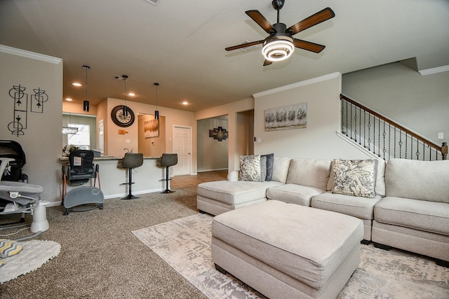 carpeted living room with baseboards, a ceiling fan, stairway, crown molding, and recessed lighting