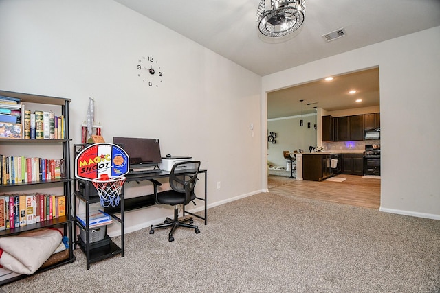 office space featuring light carpet, visible vents, baseboards, a chandelier, and recessed lighting
