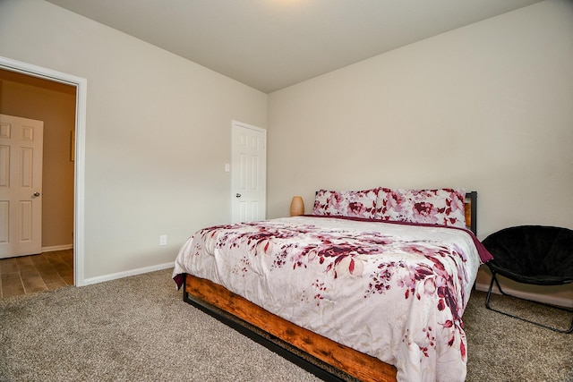 carpeted bedroom featuring baseboards