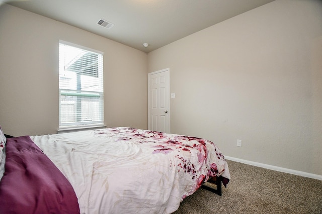 carpeted bedroom with baseboards and visible vents