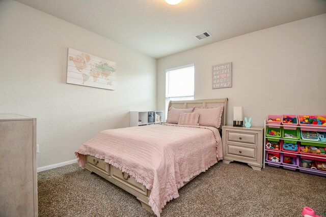carpeted bedroom featuring visible vents and baseboards
