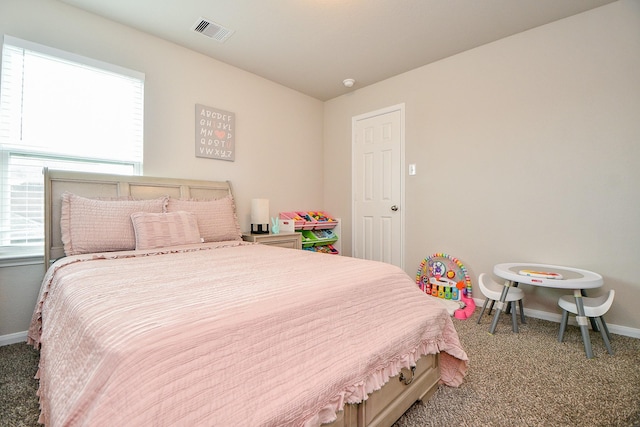 carpeted bedroom featuring baseboards and visible vents