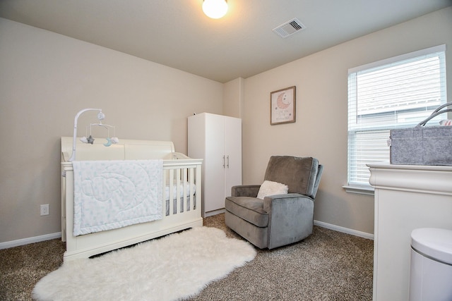 carpeted bedroom featuring a nursery area, visible vents, and baseboards