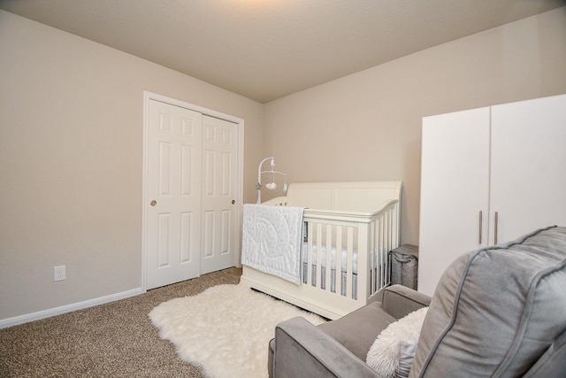 carpeted bedroom with baseboards and a closet