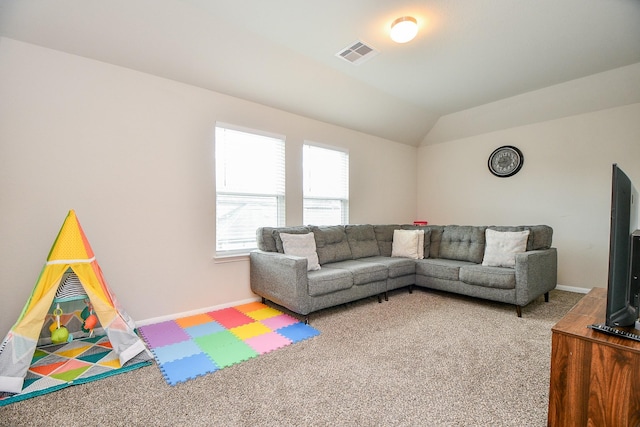 living area with carpet flooring, visible vents, baseboards, and vaulted ceiling