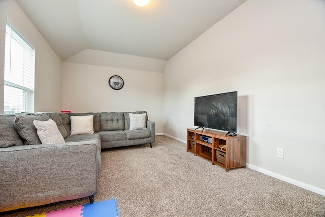 living area with lofted ceiling, carpet flooring, and baseboards