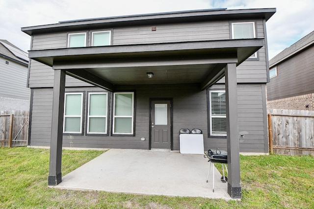 doorway to property with a patio area, fence, and a yard