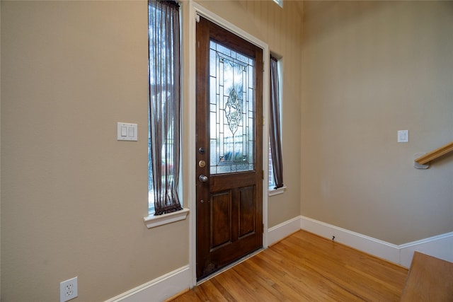 entryway with baseboards and light wood-style floors