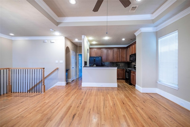 kitchen featuring dark countertops, visible vents, black appliances, and a tray ceiling