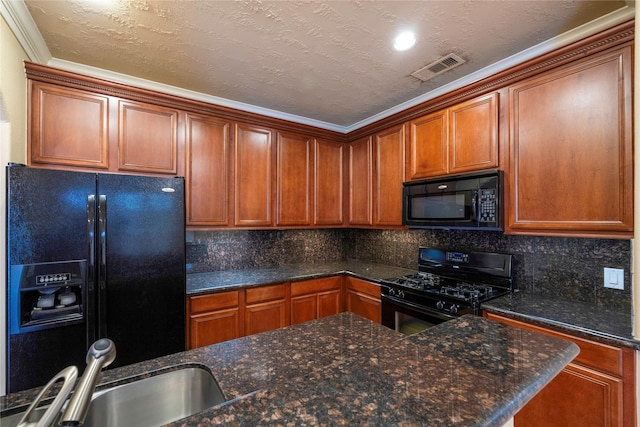 kitchen with brown cabinetry, visible vents, a sink, black appliances, and tasteful backsplash