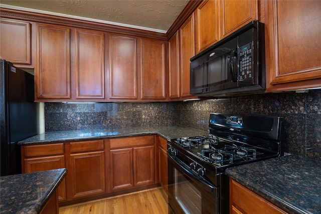 kitchen with black appliances and brown cabinetry