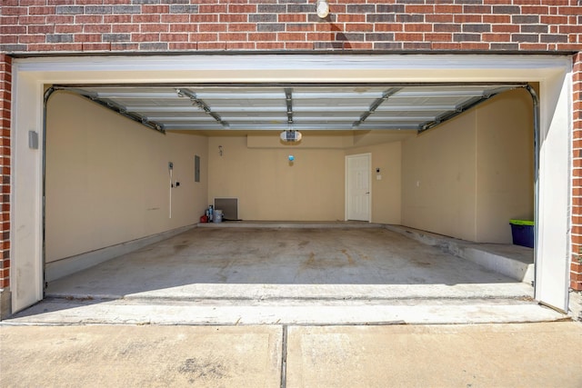 garage featuring electric panel and a garage door opener