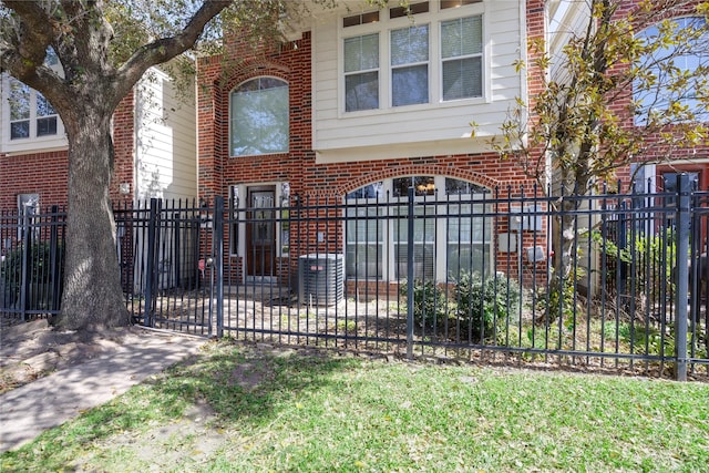 view of front facade with a fenced front yard and brick siding