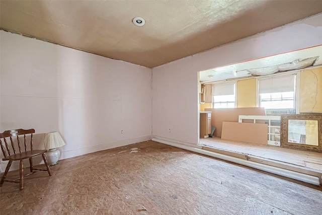 spare room featuring baseboards