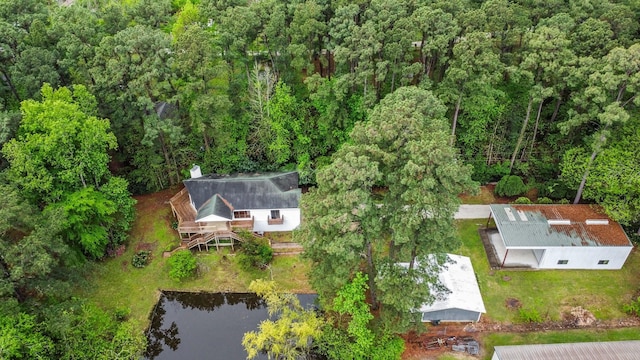 birds eye view of property featuring a water view and a view of trees