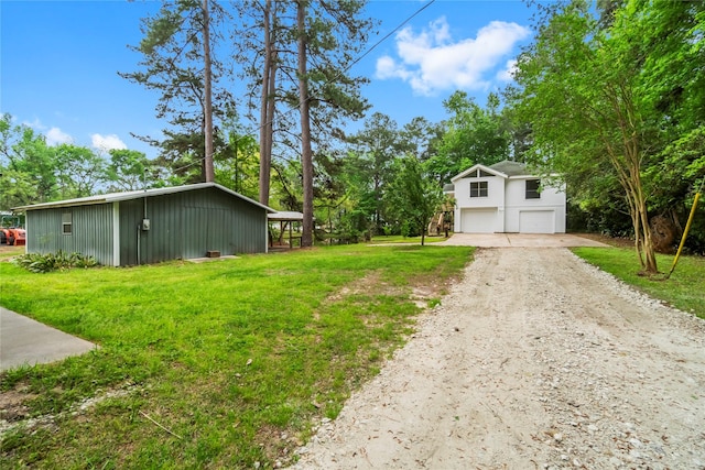 view of yard featuring a garage, an outbuilding, an outdoor structure, and dirt driveway