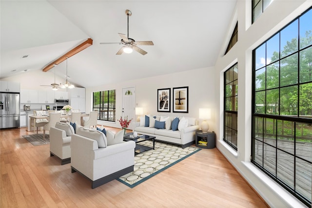 living room featuring light wood-style floors, beamed ceiling, high vaulted ceiling, and a ceiling fan