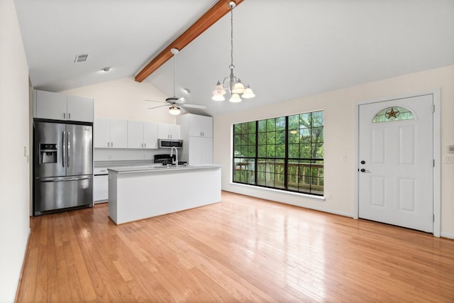 kitchen featuring appliances with stainless steel finishes, beam ceiling, visible vents, and light wood finished floors