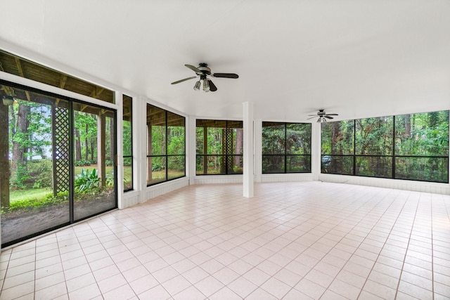 unfurnished sunroom with ceiling fan