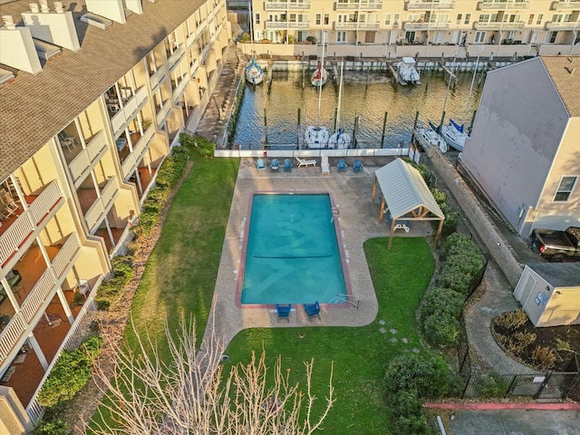 view of swimming pool featuring a water view and a boat dock