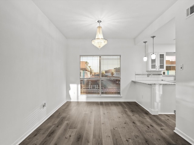 unfurnished dining area with visible vents, baseboards, and dark wood-style flooring