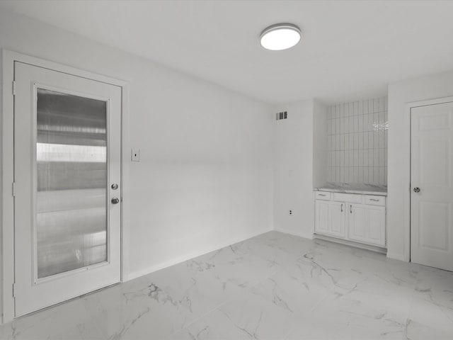 unfurnished room featuring visible vents, marble finish floor, and baseboards