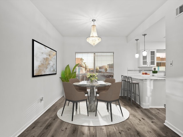 dining area with visible vents, baseboards, dark wood-style flooring, and a chandelier