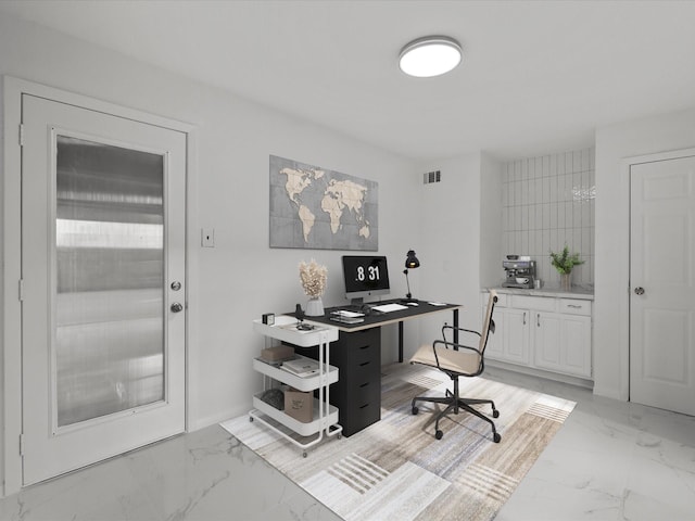 home office with visible vents and marble finish floor