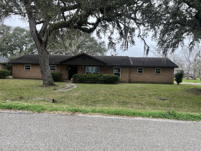 single story home featuring a front lawn and brick siding