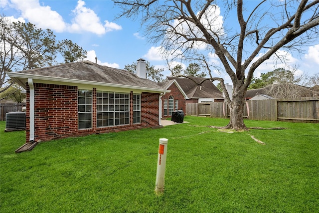 view of yard with cooling unit and a fenced backyard