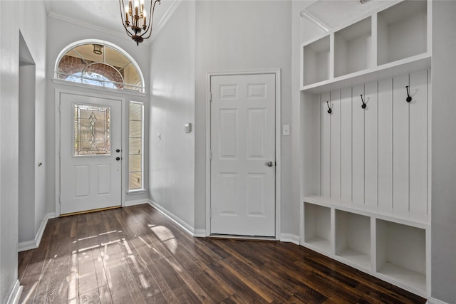 mudroom with a notable chandelier, baseboards, and dark wood-style flooring