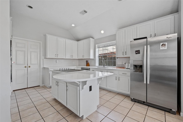 kitchen featuring visible vents, light countertops, light tile patterned floors, appliances with stainless steel finishes, and a sink