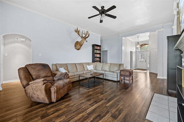 living room with hardwood / wood-style flooring, ceiling fan with notable chandelier, arched walkways, and ornamental molding