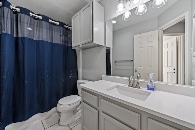 bathroom with vanity, a shower with shower curtain, a textured ceiling, tile patterned floors, and toilet