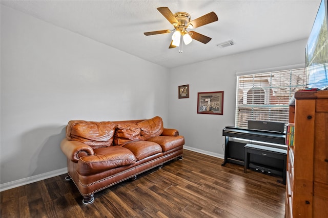 living area with ceiling fan, visible vents, baseboards, and wood finished floors