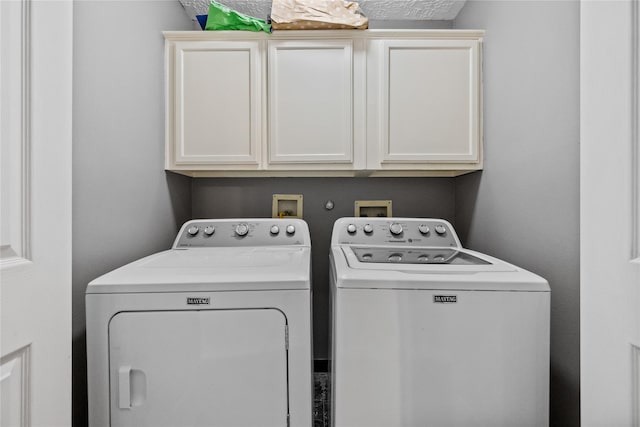 laundry room with cabinet space and washing machine and dryer