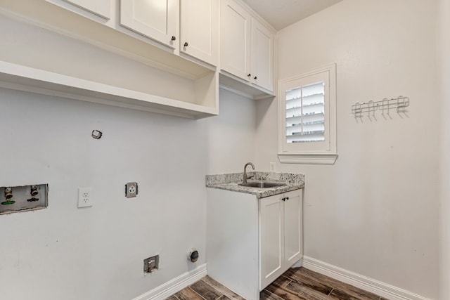 laundry room with baseboards, hookup for a gas dryer, dark wood-type flooring, hookup for a washing machine, and a sink