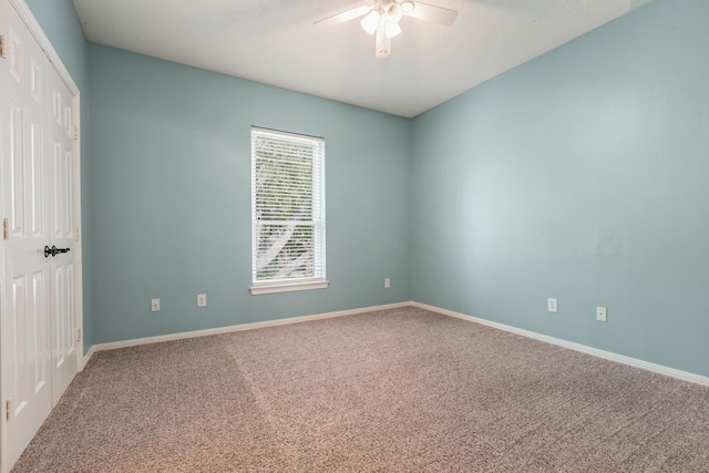 empty room with baseboards, a ceiling fan, and carpet flooring