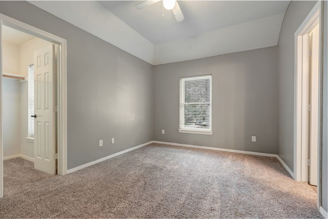 unfurnished bedroom featuring carpet floors, baseboards, and a ceiling fan