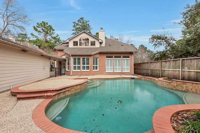 view of swimming pool featuring fence, a fenced in pool, and a patio