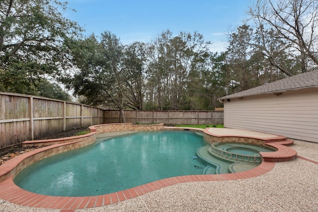 view of pool with a fenced backyard and a pool with connected hot tub