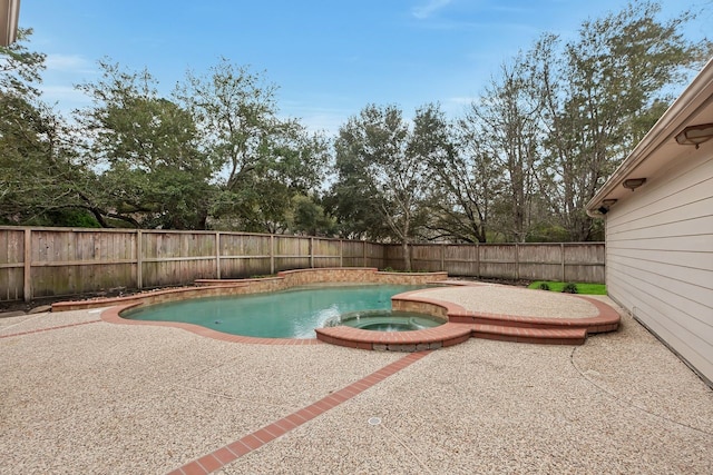 view of pool featuring a patio, a fenced backyard, and a pool with connected hot tub