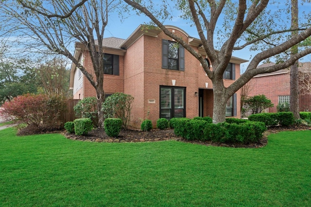 view of front of property with a front yard and brick siding